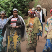 women walking down dirt path