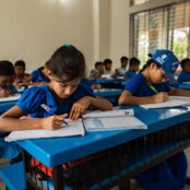 Image of Jonaki, 10, working on an assignment in the classroom.